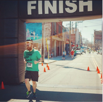 Crossing the finish at the Barley's St. Patrick's Day 5k on March 15, 2015